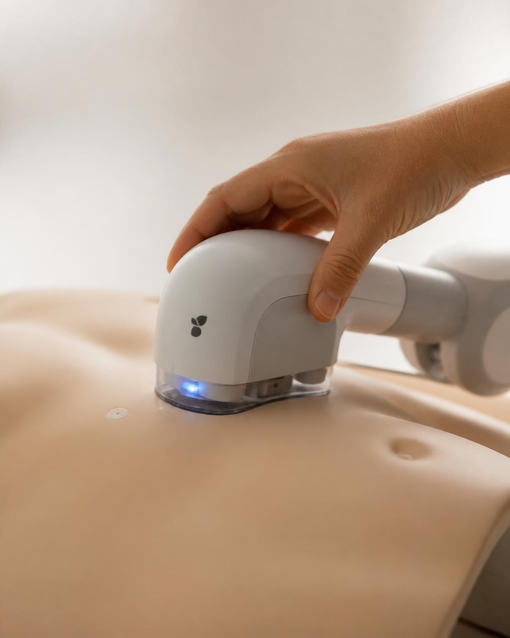 A responder’s hand placing the sleek M.A.R. CPR robot onto a patient torso